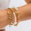 Bracelets à maillons plaqués or réglables avec perles d'imitation.